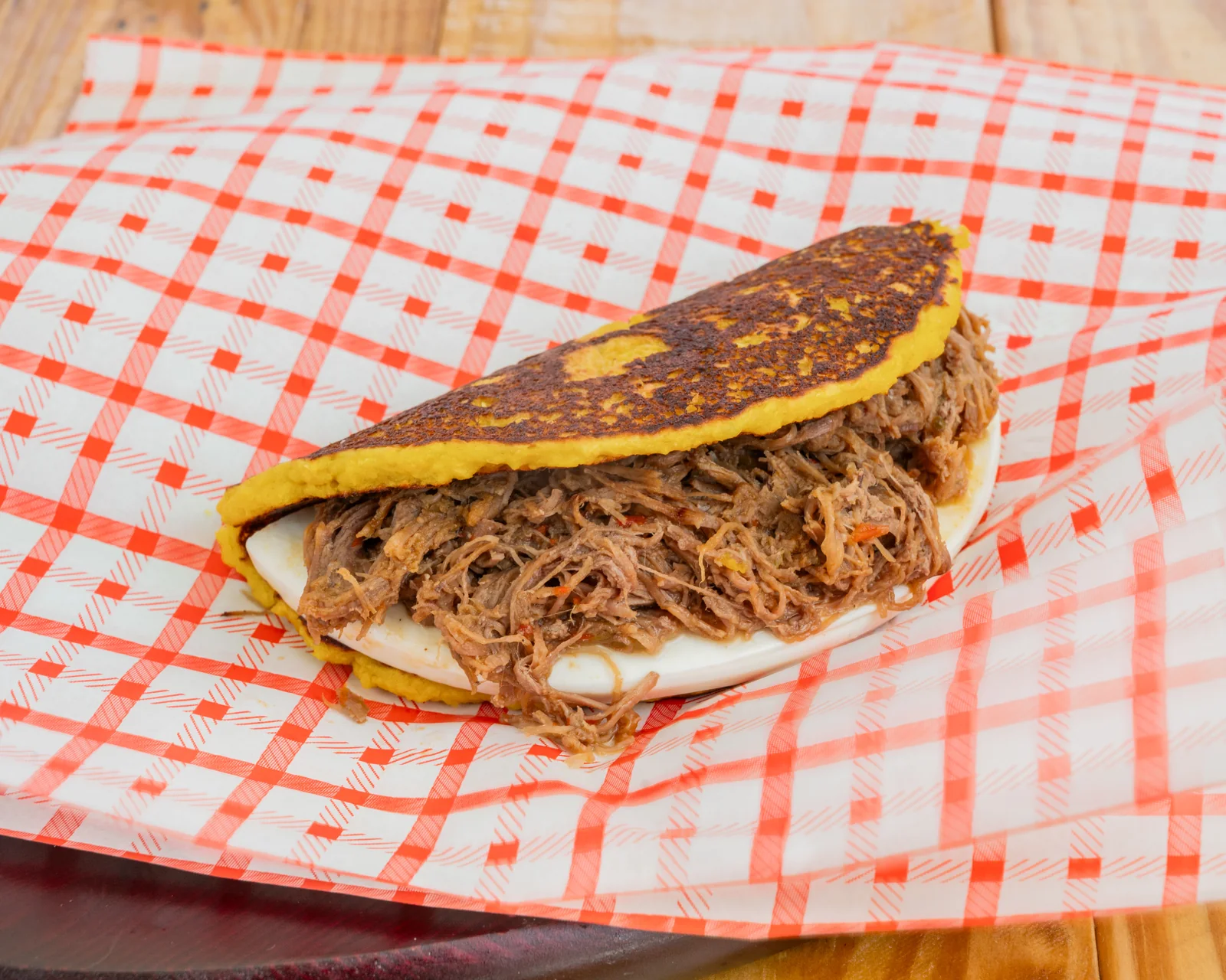 Cachapa with shredded beef and cheese