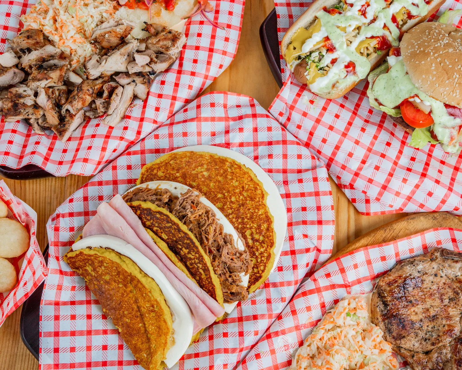 Cachapas, arepas and a burger on the table